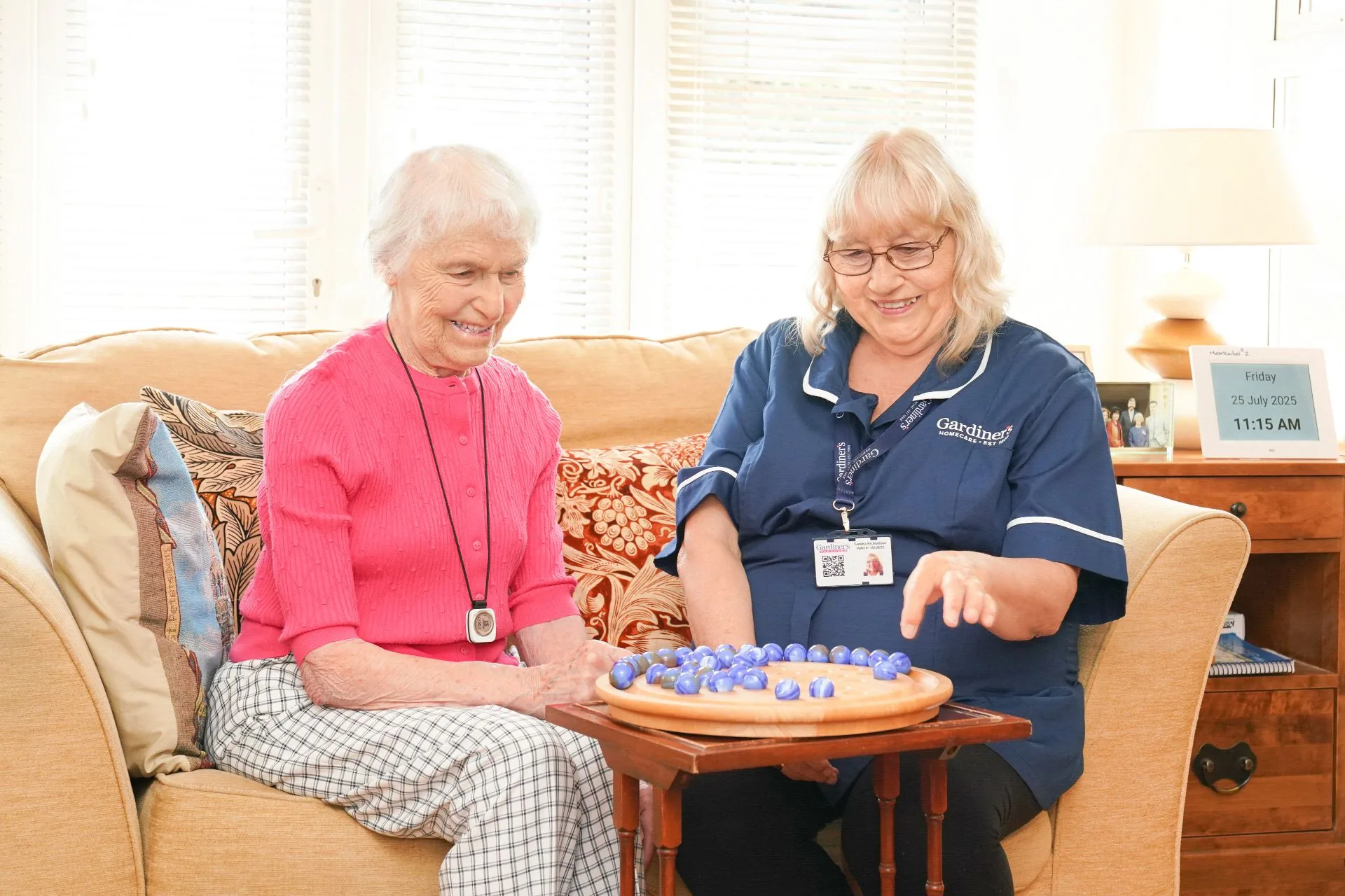 Sandra, a Gardiner's carer, sharing a game of solitaire with a client during a companionship visit