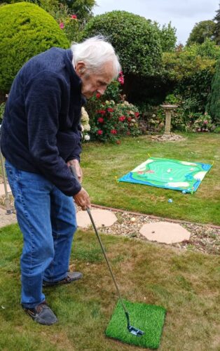 John lines up his shot